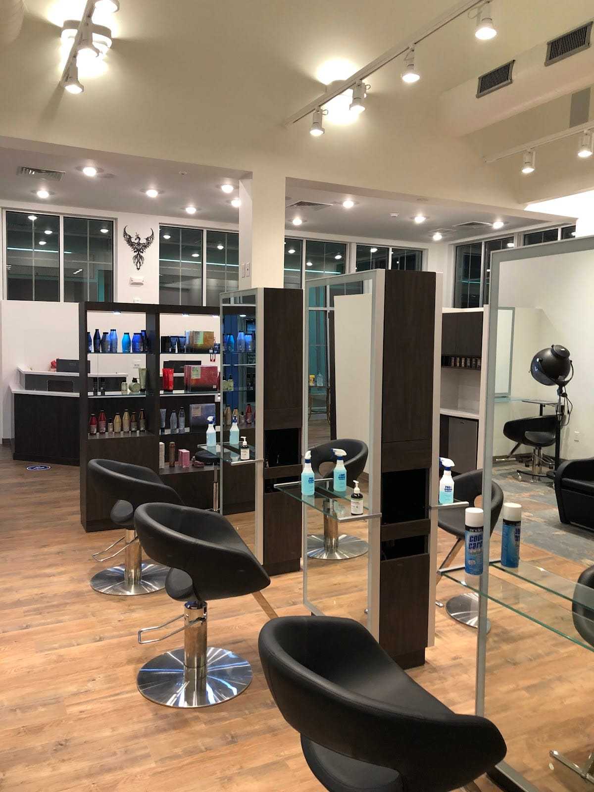 Modern hair salon interior with stylish chairs, hair products on shelves, and bright lighting.